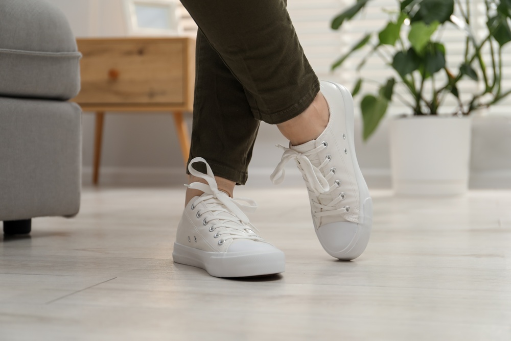 Woman wearing white sneakers