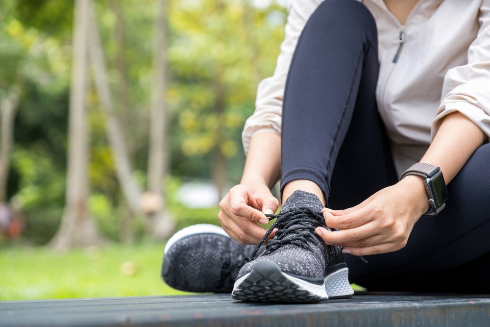 Runner tying shoes getting ready for run